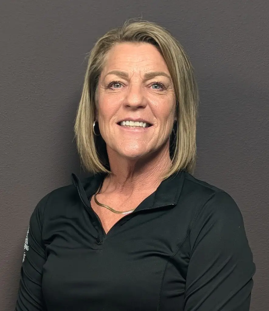 Headshot of a Female nurse with blonde hair in a black jacket